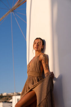Fashion photoshoot with a maxi dress against a white wall, Mykonos
